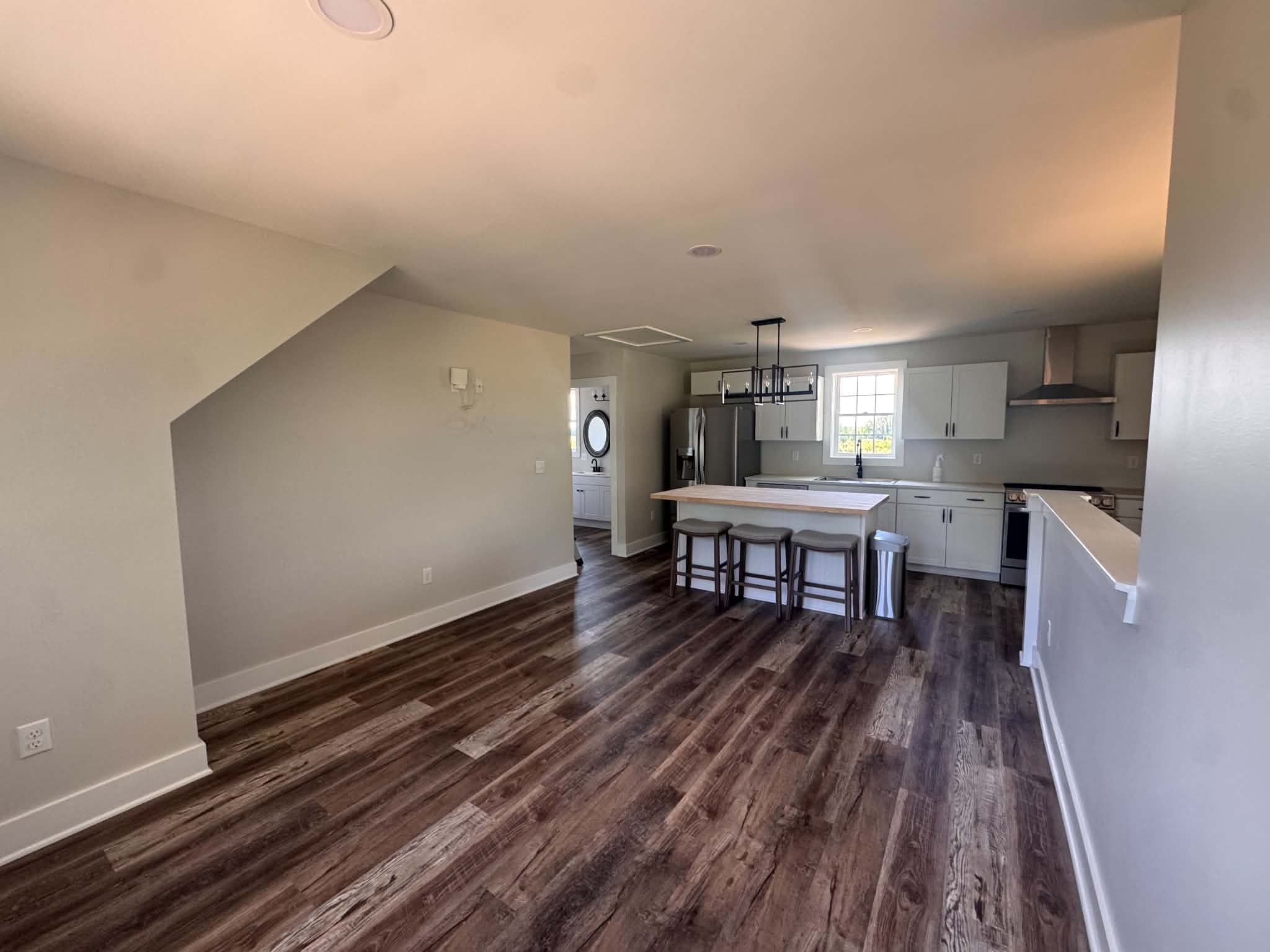 Kitchen island with seating and dark plank flooring